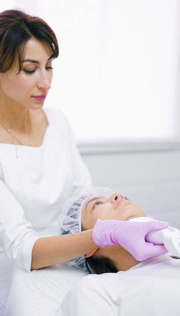 Woman receiving HIFU skin tightening on the jawline in Lahore